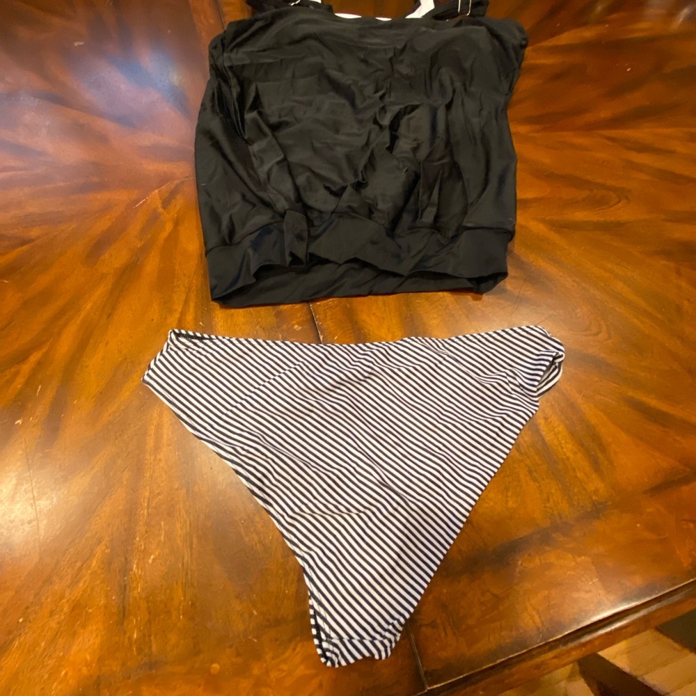 New Two Piece Bathing Suit. Size Large. Solid black top with striped bottom.
